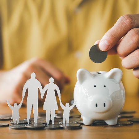 Patient in Fresno saving in piggy bank for dental crowns