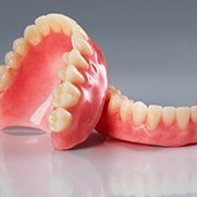 Full dentures sitting on a reflective surface