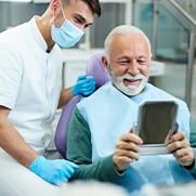 Senior man smiling while looking at reflection