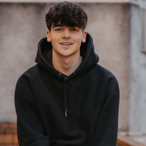 teen boy in hoodie smiling 