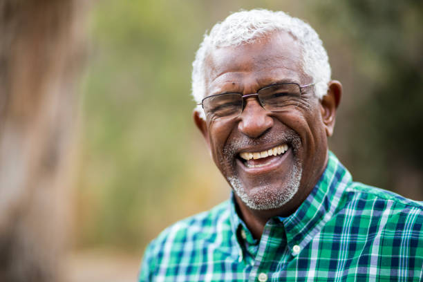 older person with dental implants smiling